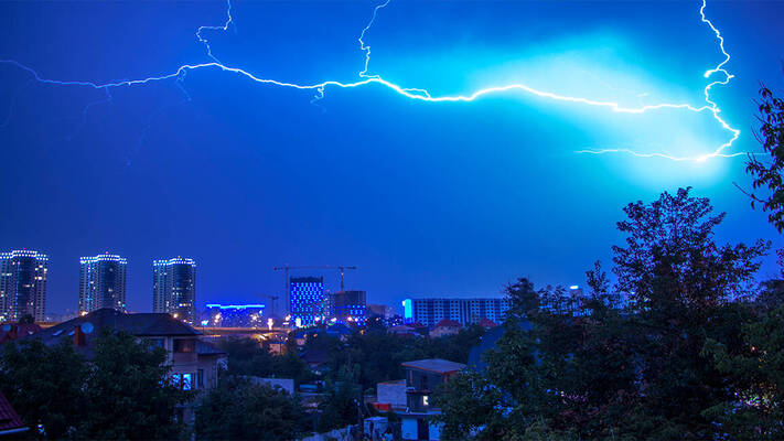 Skyline by night with thunders